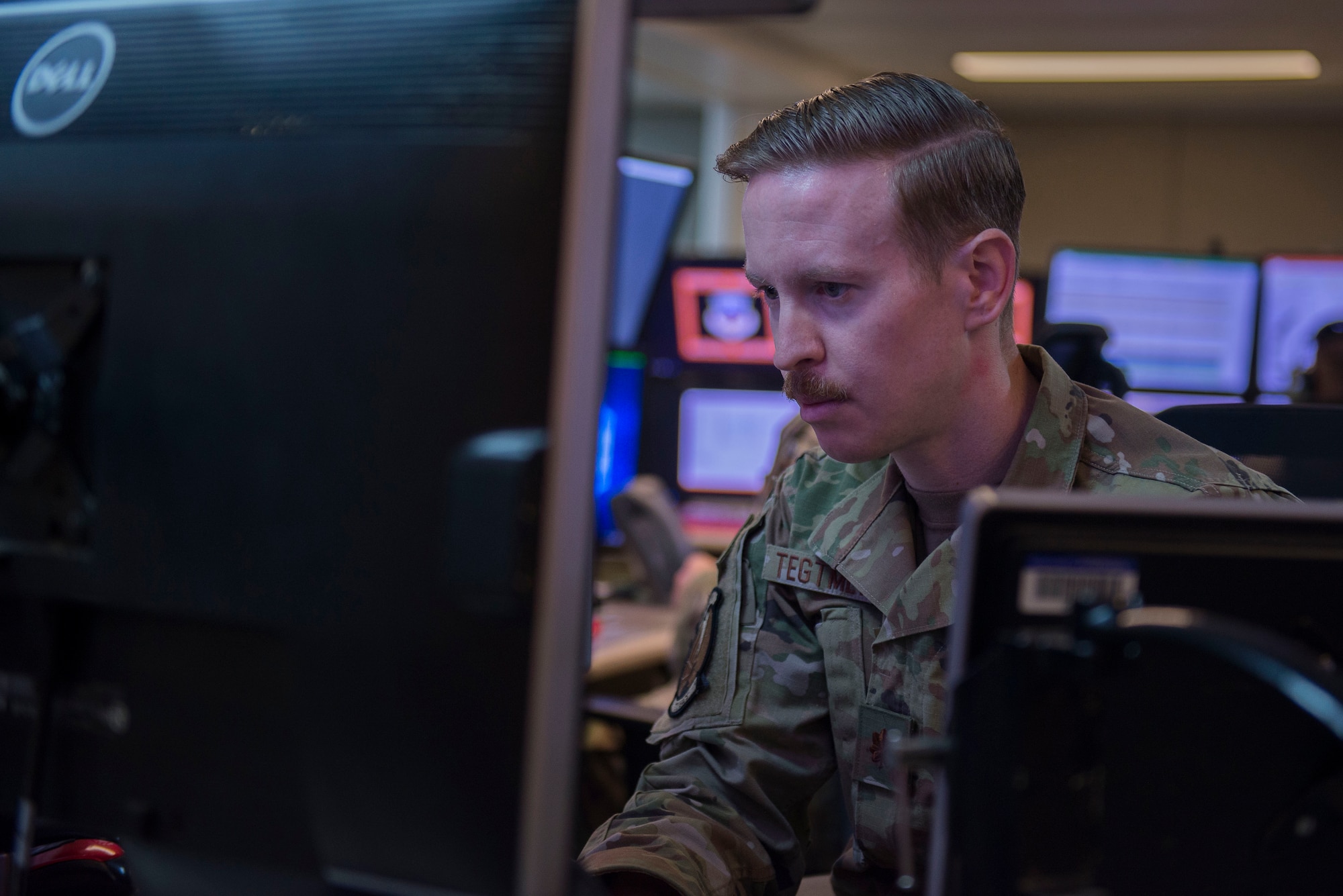 U.S. Air Force Maj. Christopher Tegmeyer, 727th Expeditionary Air Control Squadron, also known as “Kingpin,” mission commander, monitors information during Air Missile and Defense Exercise (AMDEX) 21-1 at Al Dhafra Air Base, United Arab Emirates, Oct. 23, 2020.