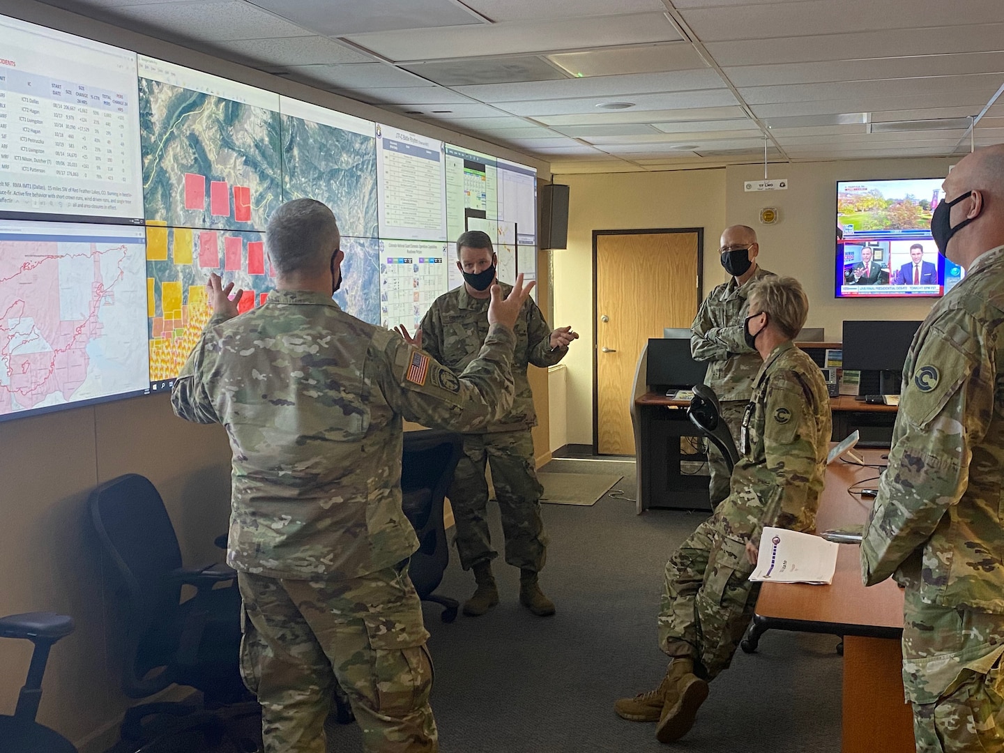 U.S. Army Brig. Gen. Laura Clellan, U.S. Army Brig. Gen. Scott M. Sherman, Lt. Col. Michael J Bruno and other leaders conduct a wildfire situation brief in the Joint Operations Center, Centennial, Colo., Oct 22, 2020. The team was reviewing fire development throughout Colorado.