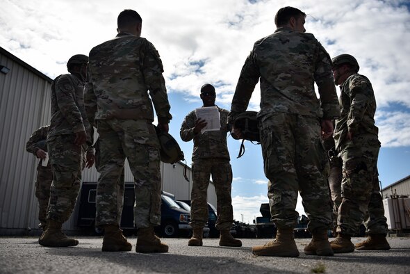 A photo of Airmen in a huddle.