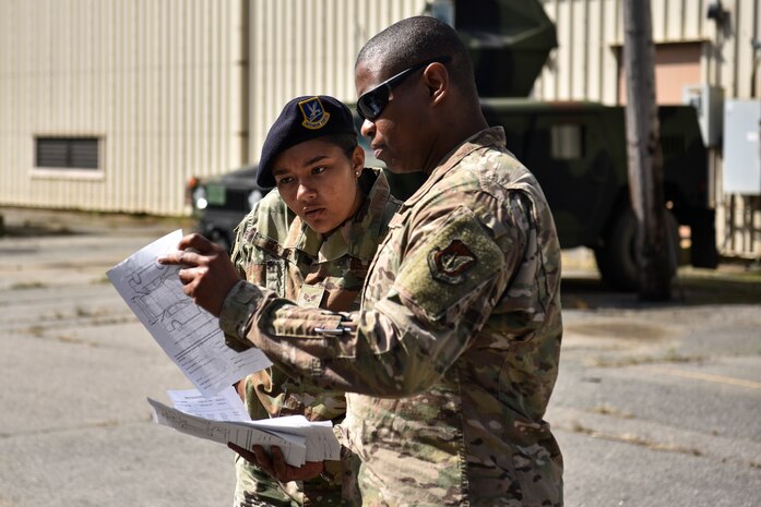 A photo of Airmen reviewing inspection documents.