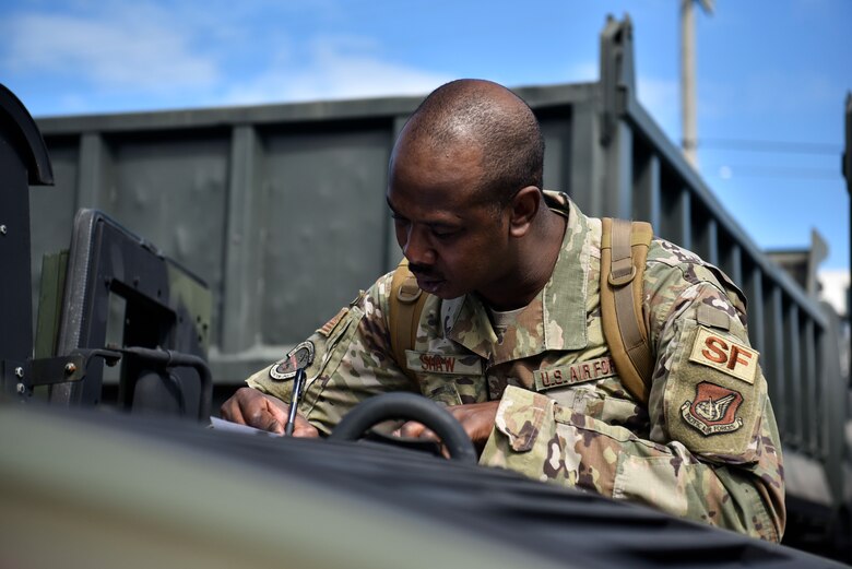 A photo of an Airman filling out paperwork.