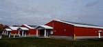 Photovoltaic panels are affixed to buildings at the New Hampshire National Guard Training Site in Center Strafford. The panels produce enough power to run the site's operation center, known as Cooper House. The NHNG aims to achieve energy resiliency at the site.