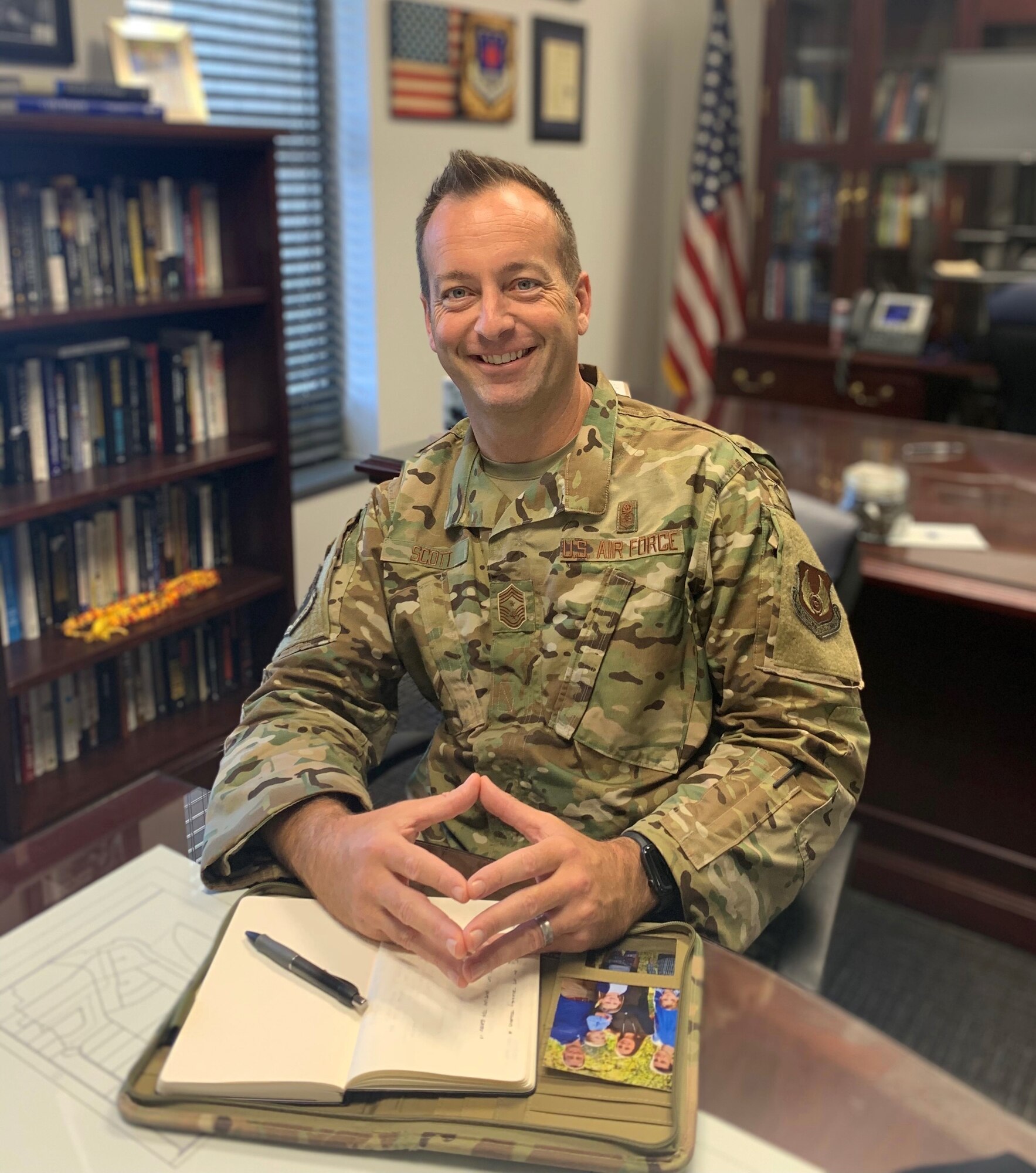 Photo of military man sitting at a table smiling
