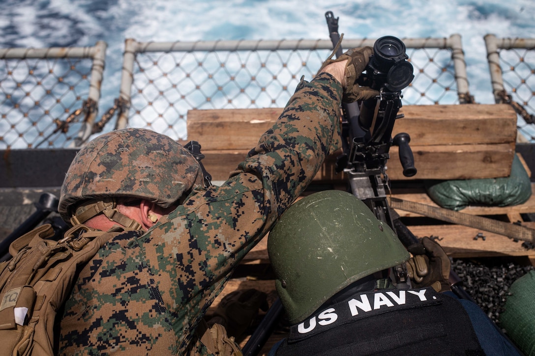 A U.S. Navy Sailor and Marine operate a M240B medium machine gun during a crew served weapons shoot Sep. 21.