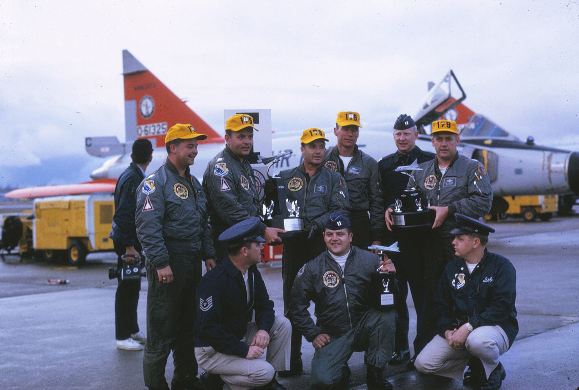 Pilots, weapons controllers and aircraft maintenance personnel pose for a photo with the three trophies presented to the 148th Fighter Group at the 1970 William Tell gunnery competition at Tyndall Air Force Base, Florida.
