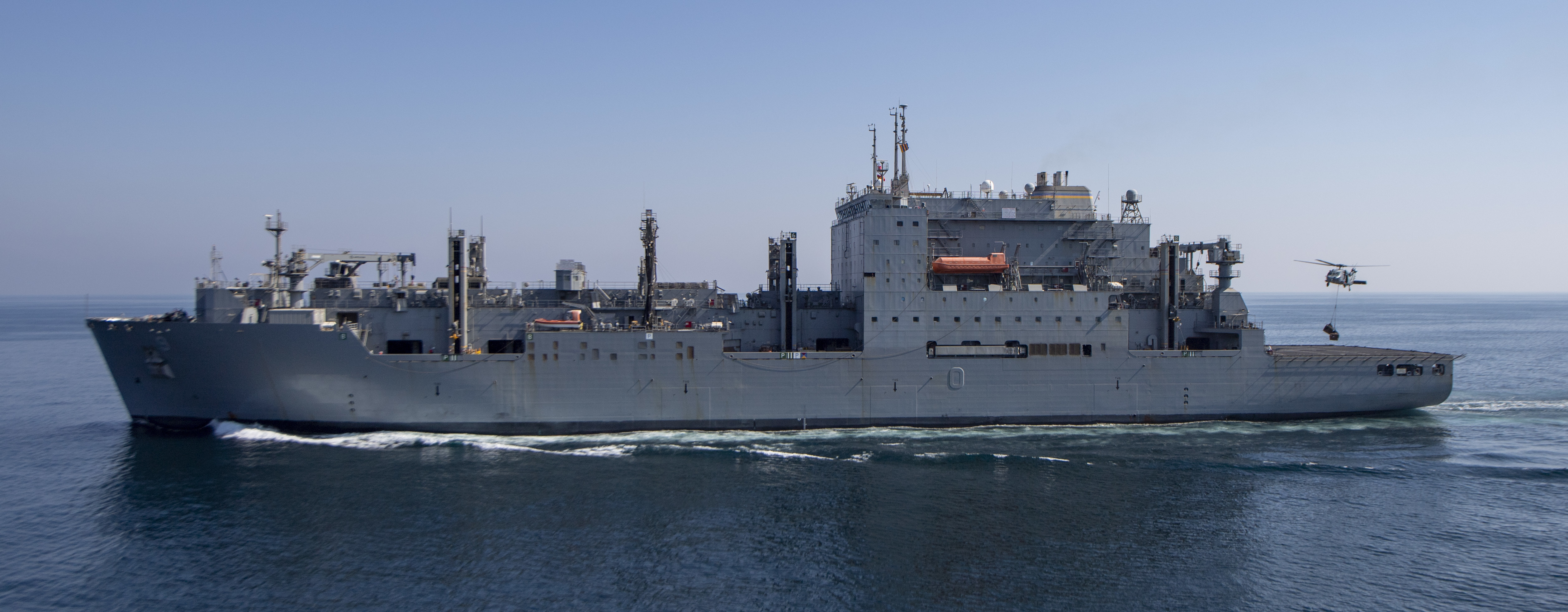 The Lewis and Clark-class dry cargo ship, the USNS Matthew Perry (T-AKE-9), steams alongside the aircraft carrier USS Nimitz (CVN 68) during a vertical-replenishment-at-sea.