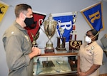 Petty Officer 2nd Class Jasmine Harris, Navy Talent Acquisition Group San Antonio assistant command career counselor, briefs Cmdr. Nicholas Gamiz, NTAG San Antonio commanding officer, on the Command Career Counselor Program at NTAG San Antonio headquarters in August.