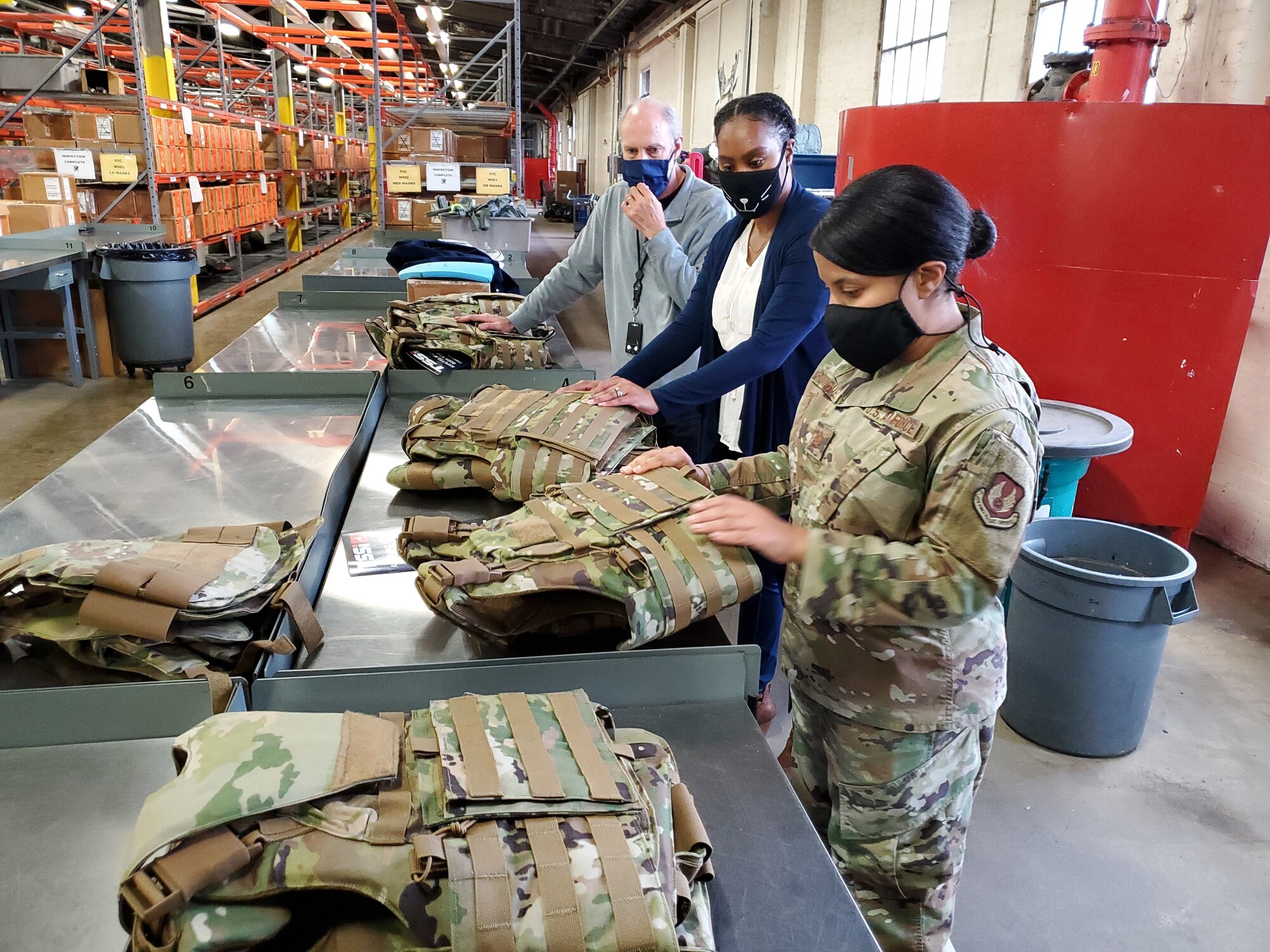 Dr. Daniel Mountjoy (left), Christine Villa, and Maj. Saily Rodriguez, with the Air Force Life Cycle Management Center's Human Systems Division, perform an inspection on new body armor units designed specifically for female Airmen in Security Forces.  (U.S. Air Force photo / Brian Brackens)