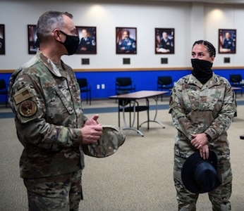 U.S. Chief Master Sgt. Erik Thompson (left), command chief for Air Education and Training Command, talks with Senior Master Sgt. Lorenda Wong (right) 737th Training Support Squadron superintendent, during a tour of the Pfingston Reception Center Oct. 15 at Joint Base San Antonio-Lackland.