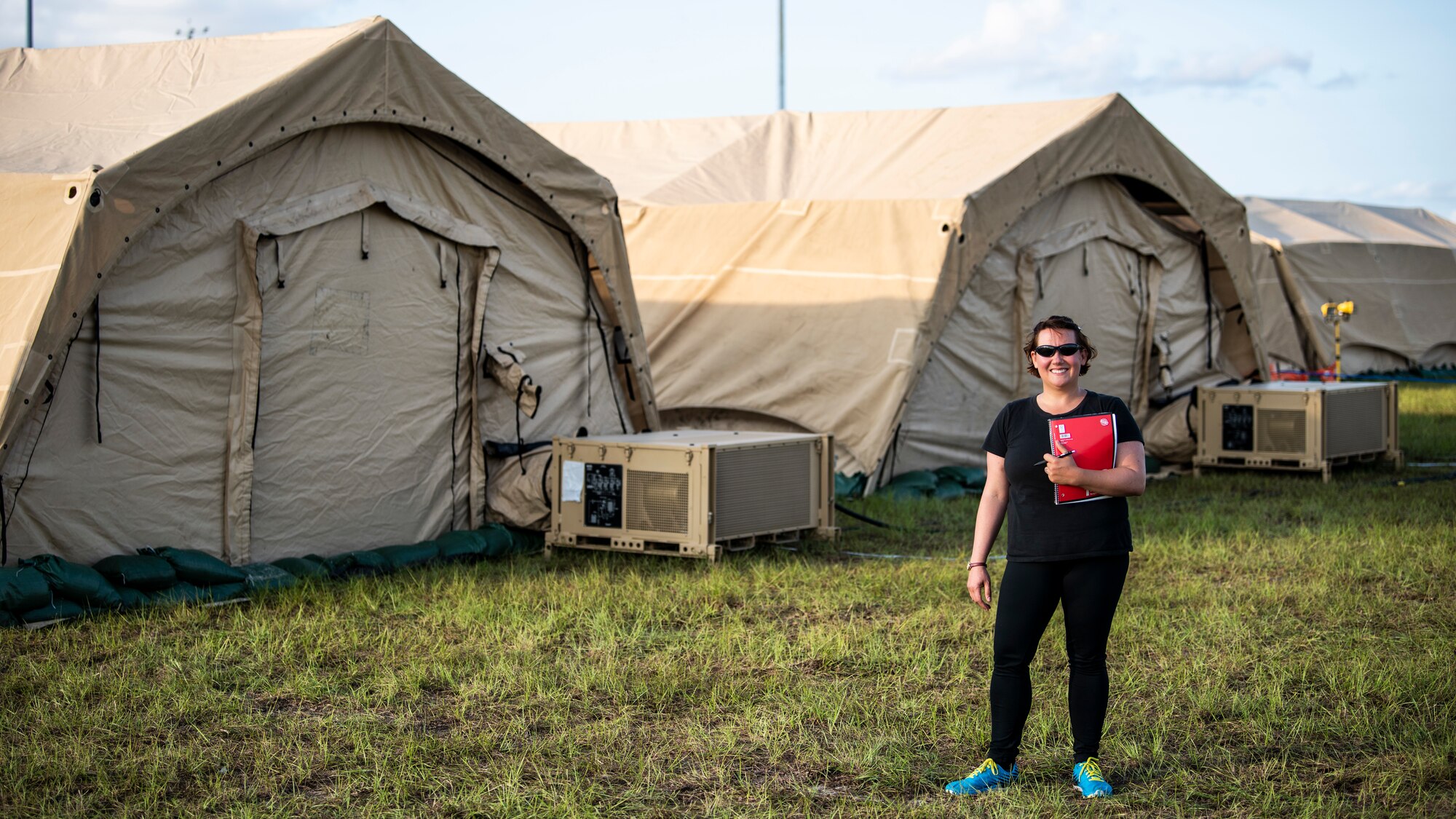 U.S. Air Force Chrissie Reilly, 366th Fighter Wing historian, holds her notebook while standing in the mobile operating base during Agile Flag 21-1 at Tyndall Air Force Base, Florida. Reilly conducts interviews, records observations and collects images that can be used for after-action reports and archived for historical record. (U.S. Air Force photo by Senior Airman Andrew Kobialka)