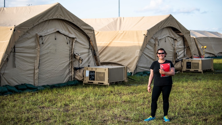 U.S. Air Force Chrissie Reilly, 366th Fighter Wing historian, holds her notebook while standing in the mobile operating base during Agile Flag 21-1 at Tyndall Air Force Base, Florida. Reilly conducts interviews, records observations and collects images that can be used for after-action reports and archived for historical record. (U.S. Air Force photo by Senior Airman Andrew Kobialka)
