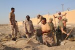 Soldiers from Forward Support Company, 891st Engineer Battalion, team up with soldiers from the Kuwaiti Land Forces to reconstruct fighting positions in the Land Force Institute’s combat course Oct. 7, 2020. Soldiers from both nations will continue to partner throughout October.