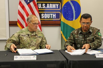 Maj. Gen. Daniel R. Walrath (left), U.S. Army South commanding general, and General de Brigada Otávio Rodrigues de Miranda Filho, 5th deputy chief of staff for the Brazilian Army, sign documents to approve agreed-to-actions and a five year plan between the two armies to conclude the U.S., Brazil army-to-army staff talks at Army South headquarters, Fort Sam Houston, Texas, Oct. 23.

The U.S. Army Staff Talks Program serves as a bilateral engagement for military discussion between respective armies. This year marks the 36th time the U.S. Army and the Brazilian Army have met for staff talks, a weeklong series of meetings that is instrumental in enhancing interoperability and cooperation between the two partners.