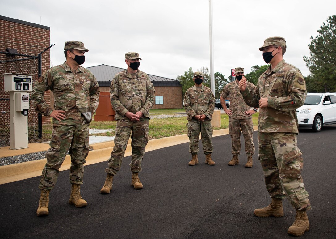 Airmen talk amongst each other about a new government vehicle fuels facility that's opening on Joint Base Langley-Eustis, Virginia.