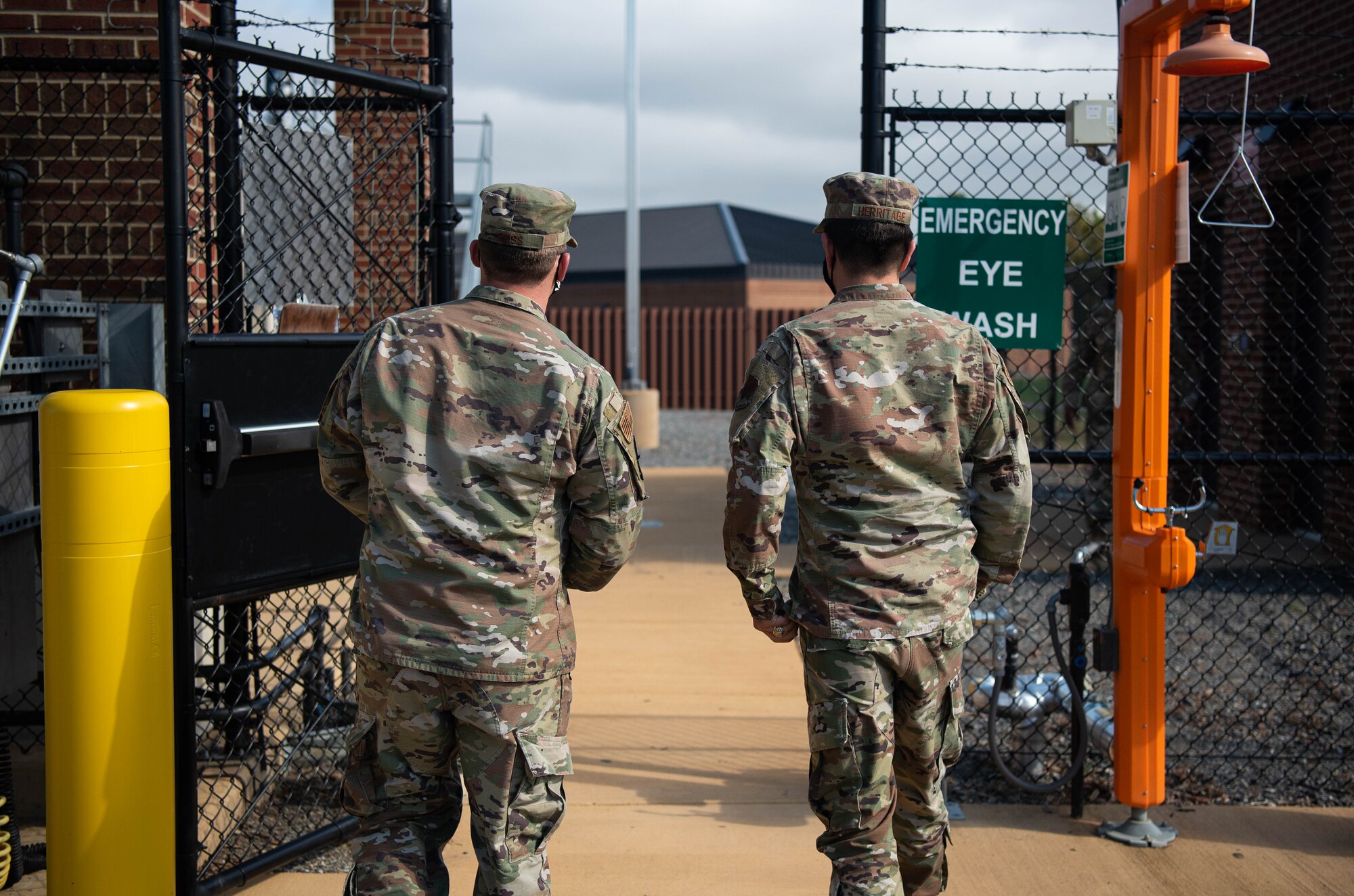 Two Airmen take a tour of a new ground vehicles fuels facility.