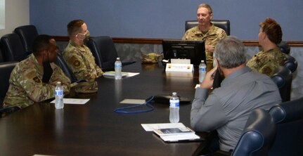 Col. Terry W. McClain, 433rd Airlift Wing commander (center), and Chief Master Sgt. Shana C. Cullum, 433rd AW command chief, meet with Col. Steven A. Strain 502nd Installation Support Group commander, Chief Master Sgt. Carey S. Jordan, 502nd ISG command chief, and Mark J. Tharp, 502nd ISG technical director, before a tour of the wing on Oct. 21 at Joint Base San Antonio-Lackland.