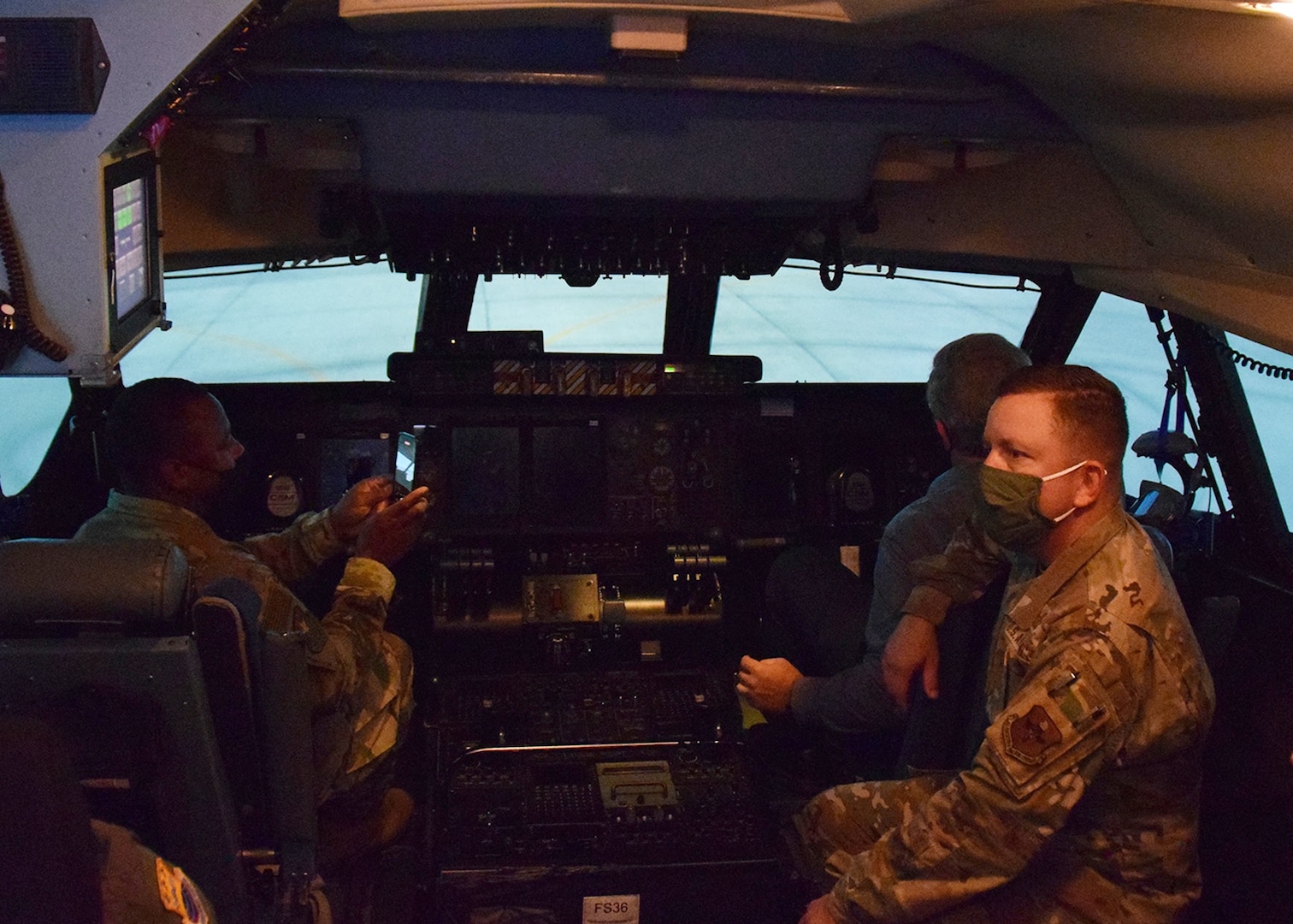 Chief Master Sgt. Carey S. Jordan, 502nd Installation Support Group command chief, Mark J. Tharp, 502nd ISG technical director, and Col. Steven A. Strain, 502nd ISG commander, tour the C-5M Super Galaxy flight simulator at the 433rd Airlift Wing’s flight training facility Oct. 21 at Joint Base San Antonio-Lackland.