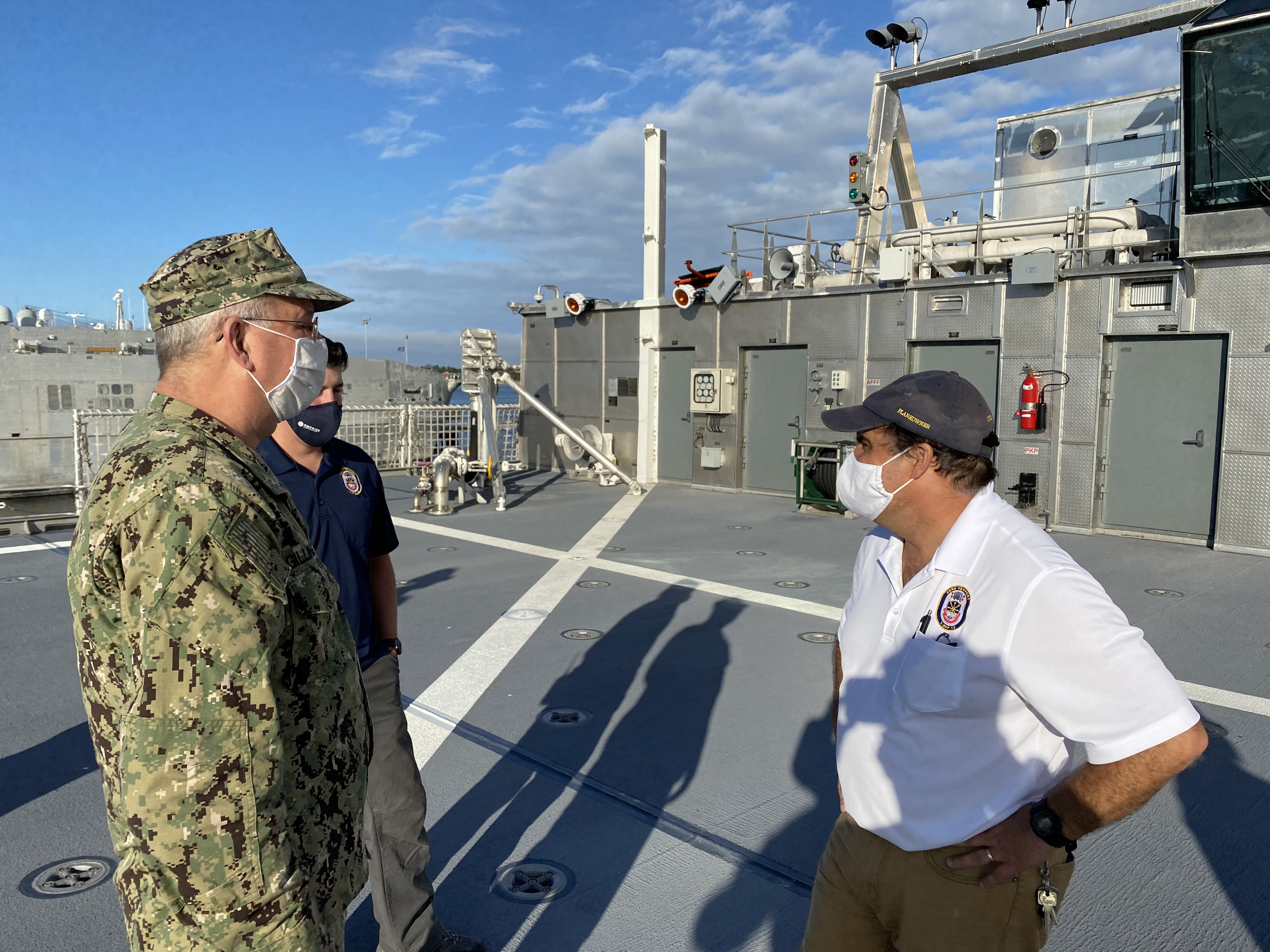 Rear Admiral Bruce Gillingham, US Navy Surgeon General, speaks with the USNS Newport Chief Mate about some of the features of the Expeditionary Fast Transport USNS Newport (T-EPF-12)