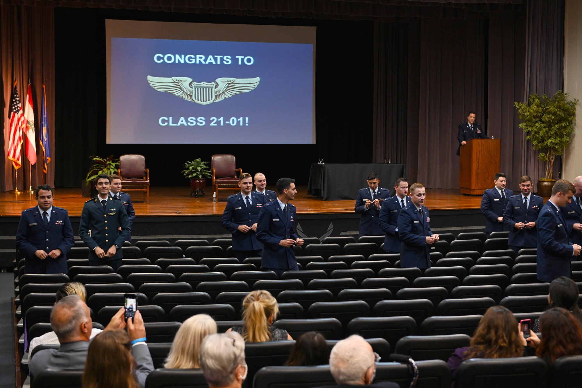 The graduating class of 21-01 stands to break their silver wings in half Oct. 23, 2020, on Columbus Air Force Base Miss. The traditional breaking of the wings symbolizes the sacrifice made to the pilots who put their lives on the line for their country. The two halves are never to be brought together again while the pilot is alive. (U.S. Air Force photo by Senior Airman Jake Jacobsen)