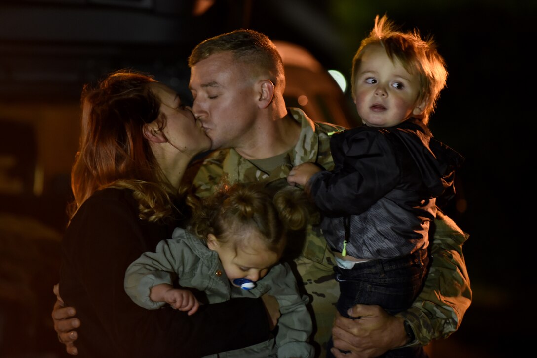 A U.S. Air Force Airman assigned to the 492nd Fighter Squadron reunites with his family at Royal Air Force Lakenheath, England, Oct. 19, 2020. The 492nd FS returned from a six-month deployment in support of Operation Inherent Resolve. (U.S. Air Force photo by Senior Airman Christopher S. Sparks)