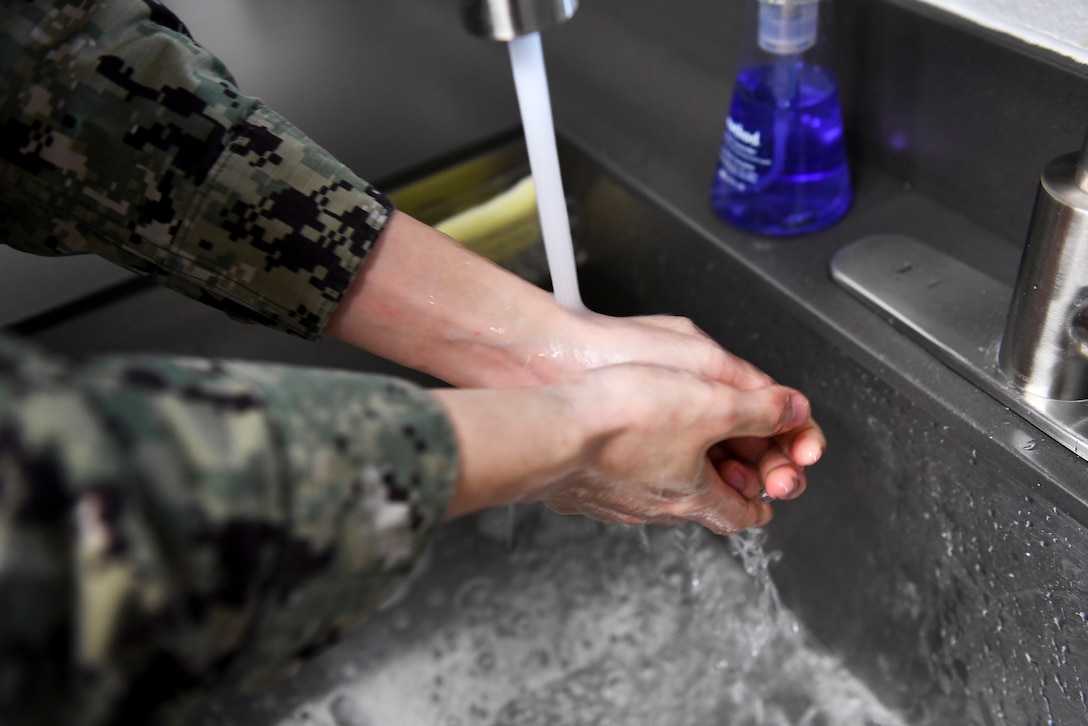 A person washes their hands.