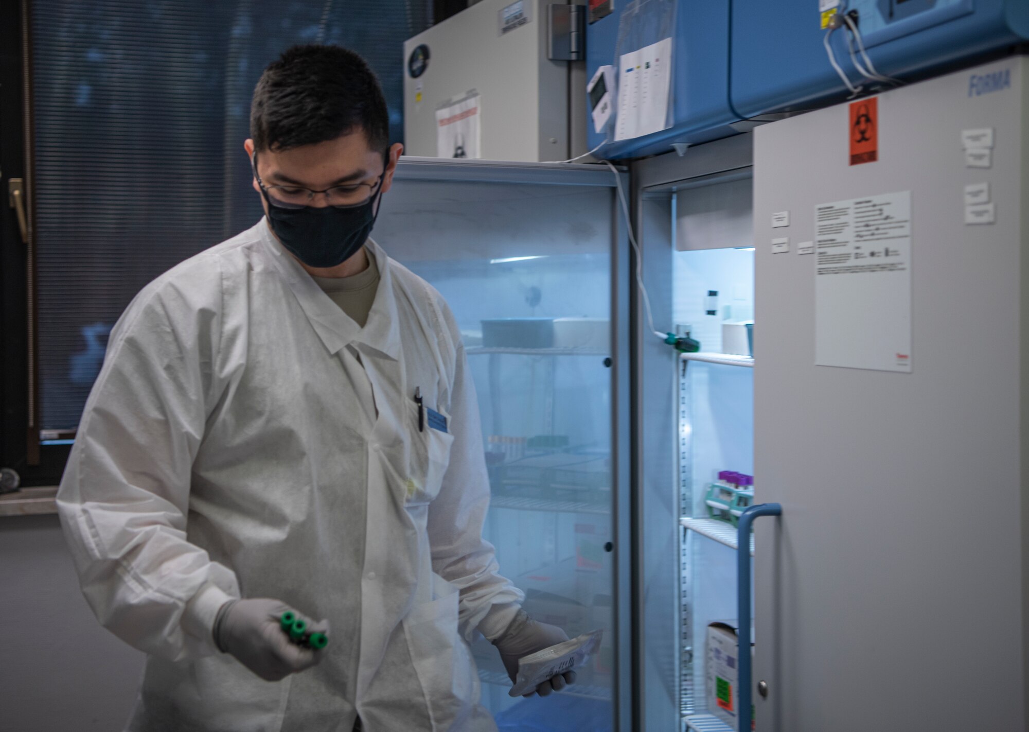 U.S. Air Force Senior Airman Moran Alexander-Luis, 86th Medical Support Squadron medical laboratory technician, takes samples from a refrigerator at Ramstein Air Base, Germany, Oct. 15, 2020. Blood samples are refrigerated at different temperatures to prevent degradation. (U.S. Air Force photo by Airman 1st Class Jennifer Gonzales)