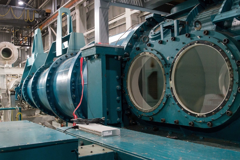 A photograph shows a large piece of machinery inside a building.