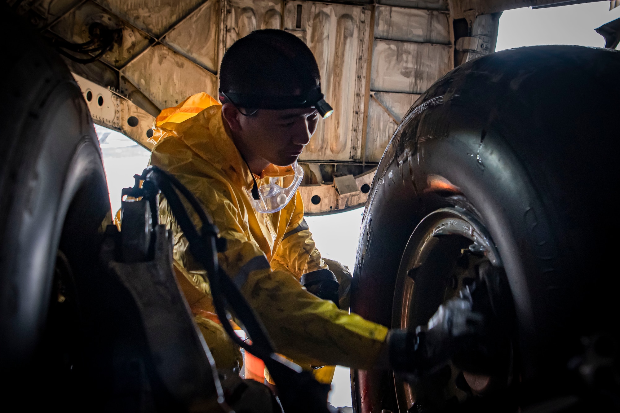 Photo of an aircraft wash specialist cleaning a C-17 Globemaster III tire.
