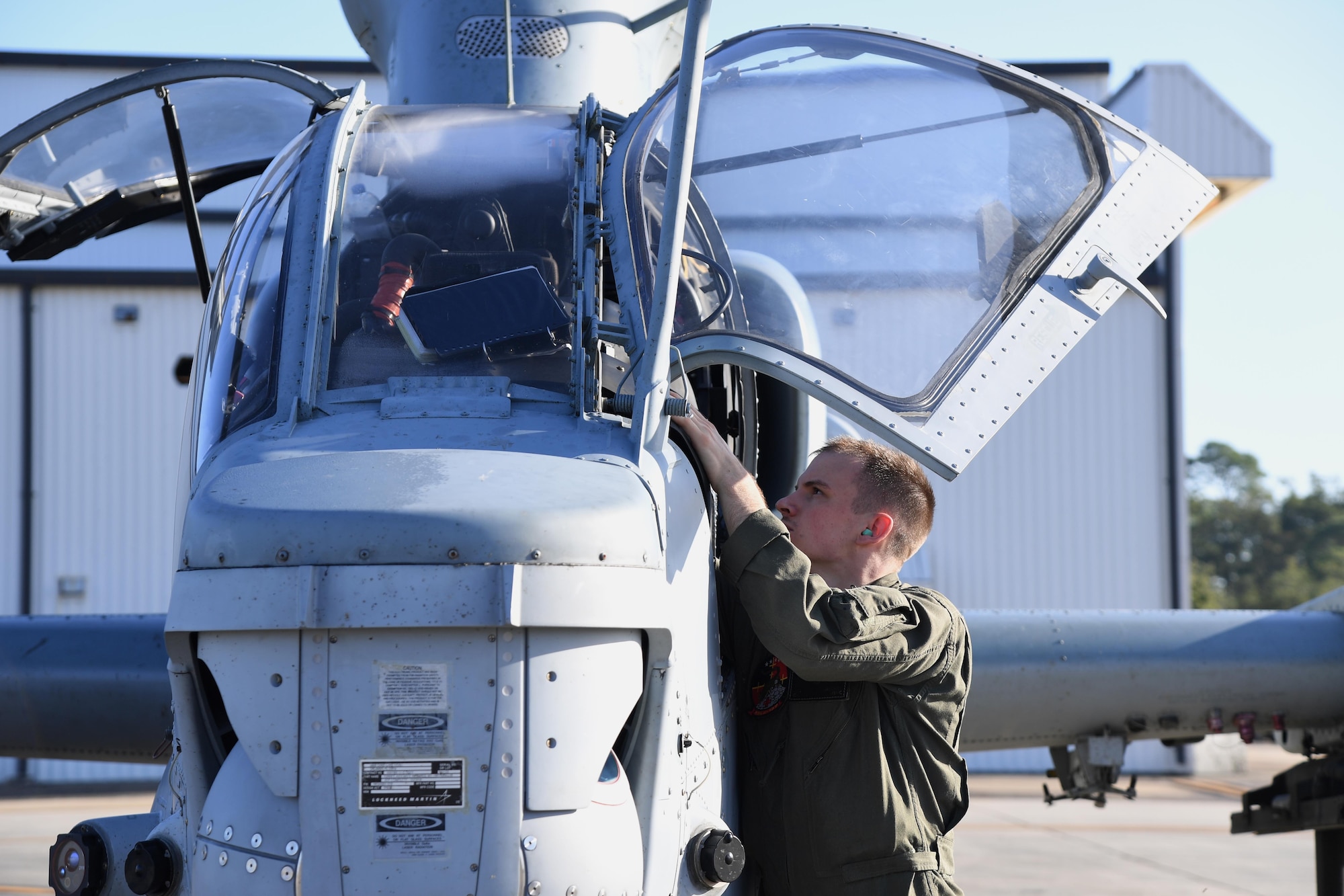 U.S. Marine Corps Capt. Jeffrey Jaeckel, Marine Light Attack Helicopter Squadron 167 AH-1Z Cobra pilot, Marine Corps Air Station New River, North Carolina,  conducts a pre-flight inspection on an AH-1Z Cobra at Keesler Air Force Base, Mississippi, Oct. 21, 2020. Two AH-1Z Cobras and two UH-1Y Hueys were at Keesler for joint training with the Marine Special Operations Command during their RAVEN exercise from Oct. 12-21. RAVEN is the exercise Marine Raiders complete after their six-month training cycle in preparation for deployment to ensure operational readiness of the Marine Special Operations Teams. (U.S. Air Force photo by Kemberly Groue)