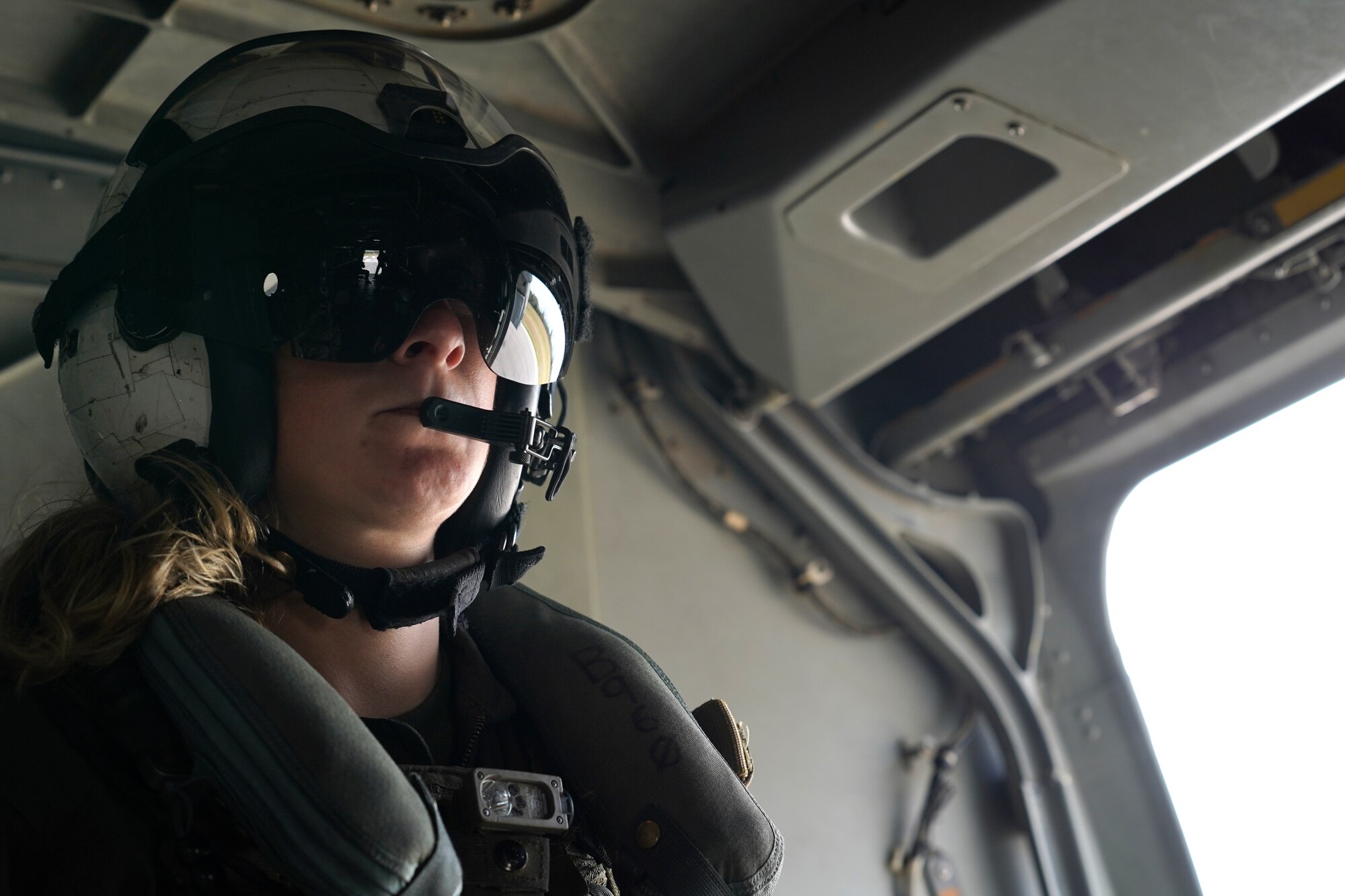 U.S. Marine Corps Sgt. Stephanie Fregoe, VMM-774 MV-22B Osprey crew chief, Naval Air Station Norfolk, Virginia, rides in an Osprey flying over Gulfport, Mississippi, Oct. 23, 2020. Marines came to Keesler to conduct routine training operations in and around the Mississippi area. (U.S. Air Force photo by Airman 1st Class Seth Haddix)