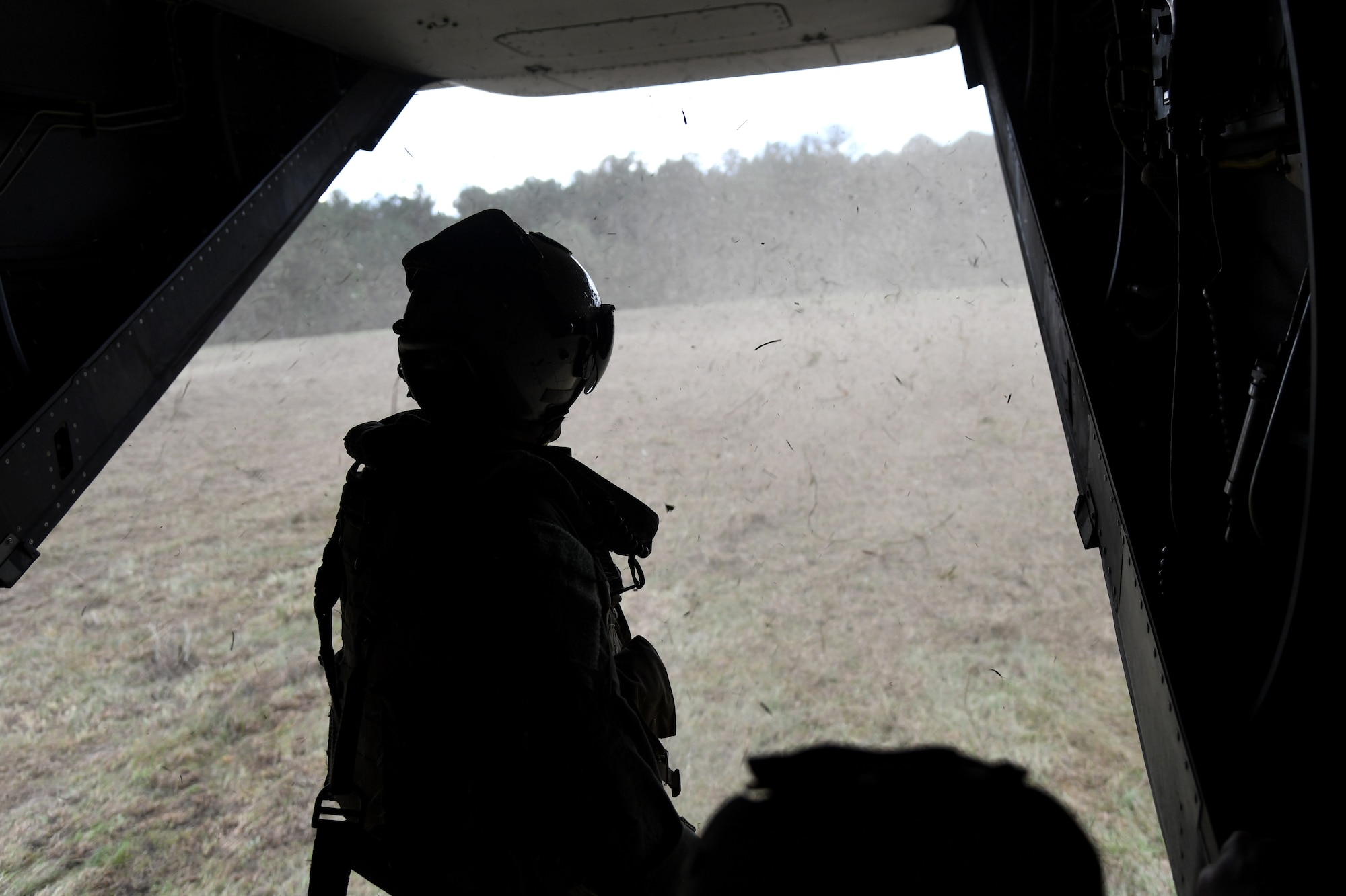 U.S. Marine Corps Staff Sgt. Jake Clark, Marine Medium Tiltrotor Squadron 774 MV-22B Osprey crew chief, Naval Air Station Norfolk, Virginia, sits on the back of a MV-22B Osprey in a field near Camp Shelby, Mississippi, Oct. 23, 2020. Marines came to Keesler to conduct routine training operations in and around the Mississippi area. (U.S. Air Force photo by Airman 1st Class Seth Haddix)