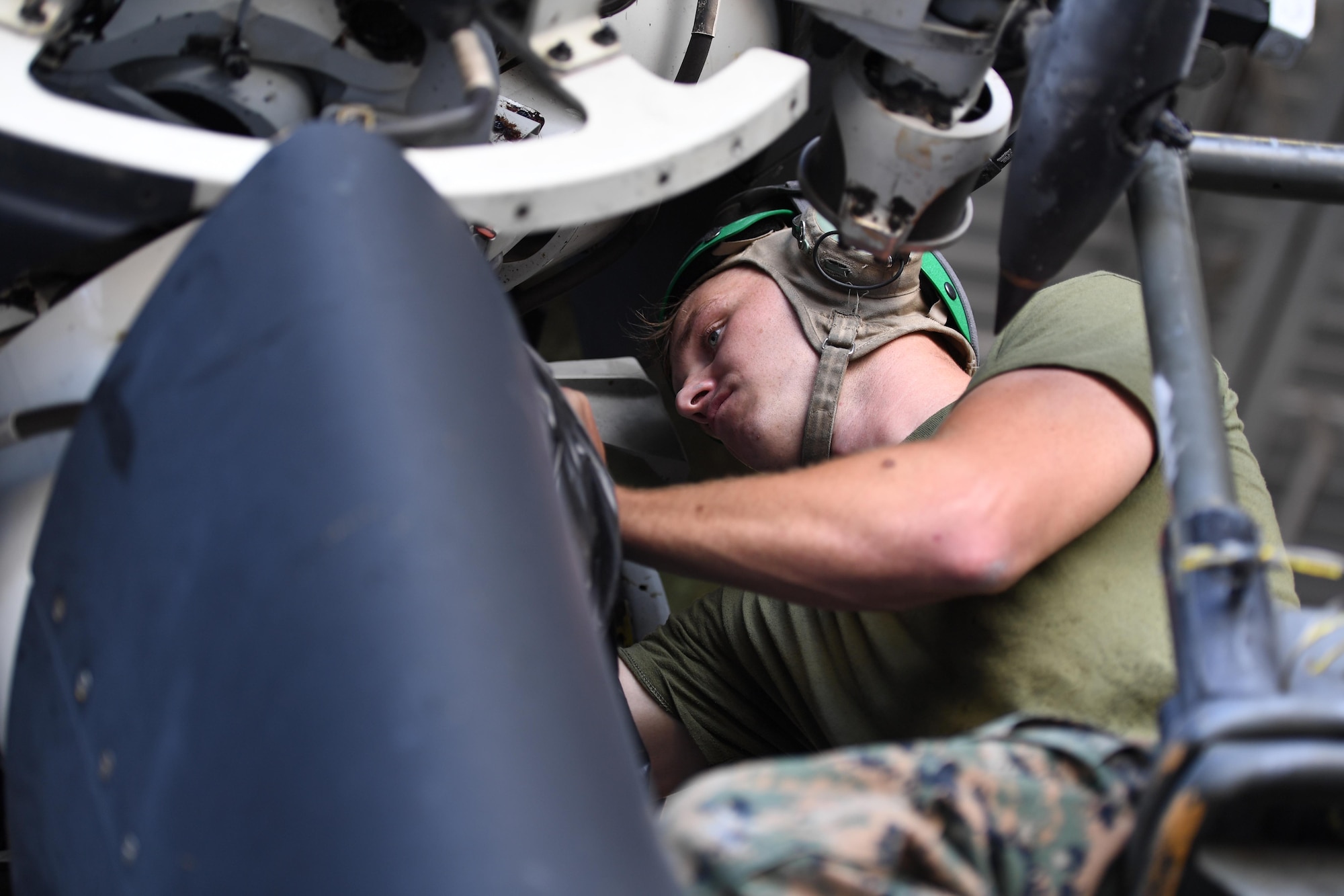 U.S. Marine Corps Lance Cpl. Patrick Stanton, Marine Medium Tiltrotor Squadron 774 air framer, Naval Air Station Norfolk, Virginia, performs routine maintenance on an MV-22B Osprey inside a hangar at Keesler Air Force Base, Mississippi, Oct. 23, 2020. Marines came to Keesler to conduct routine training operations in and around the Mississippi area. (U.S. Air Force photo by Kemberly Groue)