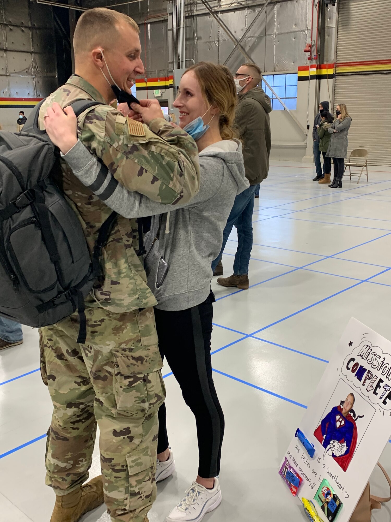 Myelie Bailey and her husband, Staff Sgt. Austin Bailey, take down their masks to get a good look at each other Sunday following Austin’s return from a six-month deployment to Al Dhafra Air Base, United Arab Emirates.