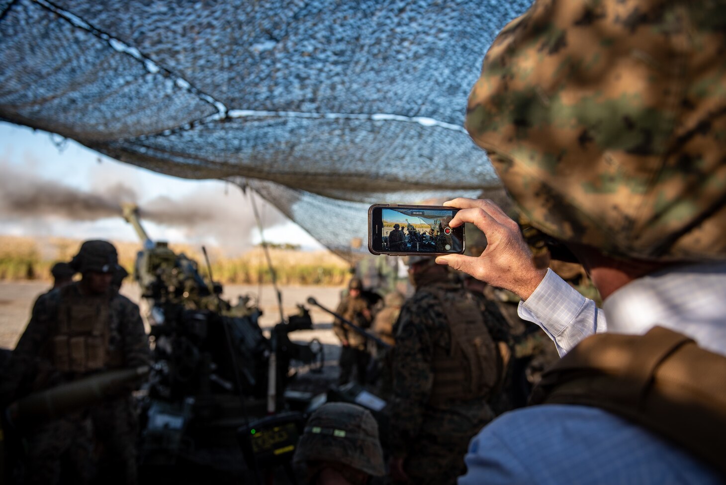 CAMP FUJI, Japan (Oct. 21, 2020) - Kevin Quinn, a science advisor for 7th Fleet, documents Marines assigned to 3rd Battalion, 12th Marine Regiment, firing an M777A2 155mm Howitzer during Artillery Relocation Training Program 20.3 at Combined Arms Training Center, Camp Fuji. 7th Fleet serves with III MEF to continually execute missions that enable maritime superiority through effective command and control, prosecution of naval fires, and operational maneuvers.
