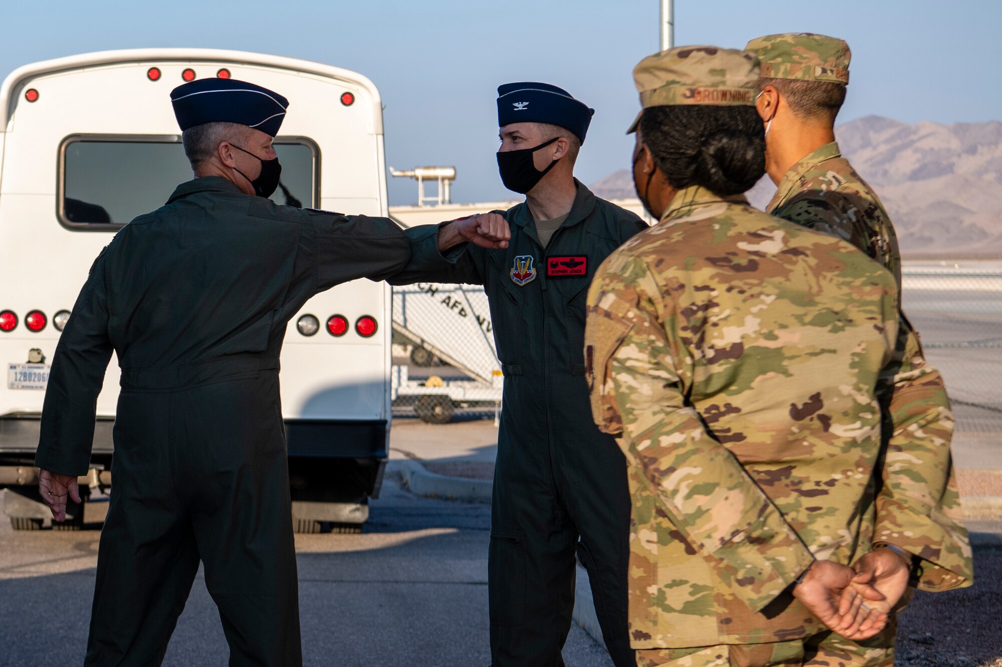 Col. Stephen Jones, right, 432nd Wing/432nd Air Expeditionary Wing commander, welcomes Gen. Mark Kelly, left, commander of Air Combat Command, to Creech Air Force Base in front of the air traffic control tower.