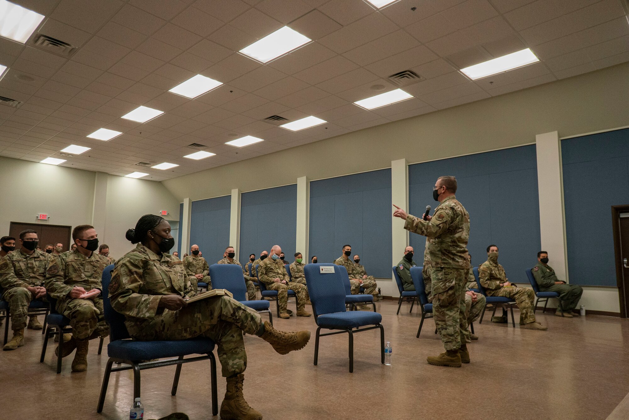 Chief Master Sgt. David Wade, command chief of Air Combat Command, speaks to enlisted members during an enlisted call in the base auditorium.
