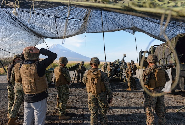 CAMP FUJI, Japan (Oct. 21, 2020) - Members of 7th Fleet staff observe Marines assigned to 3rd Battalion, 12th Marine Regiment fire an M777A2 155mm Howitzer during Artillery Relocation Training Program 20.3 at Combined Arms Training Center, Camp Fuji. 7th Fleet serves with III MEF to continually execute missions that enable maritime superiority through effective command and control, prosecution of naval fires, and operational maneuvers.