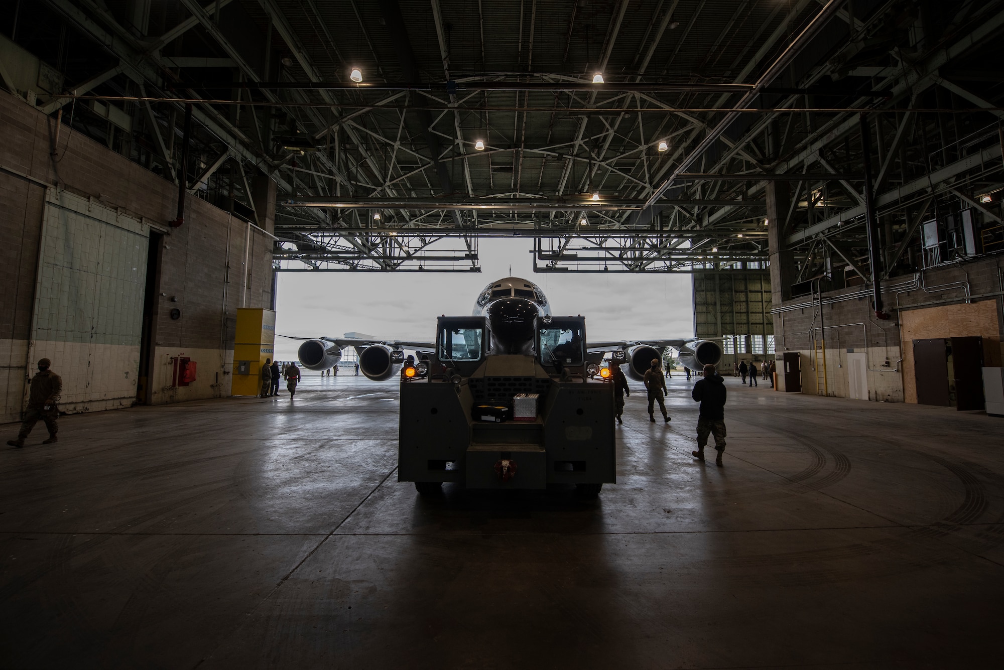 Truck tows aircraft into hangar