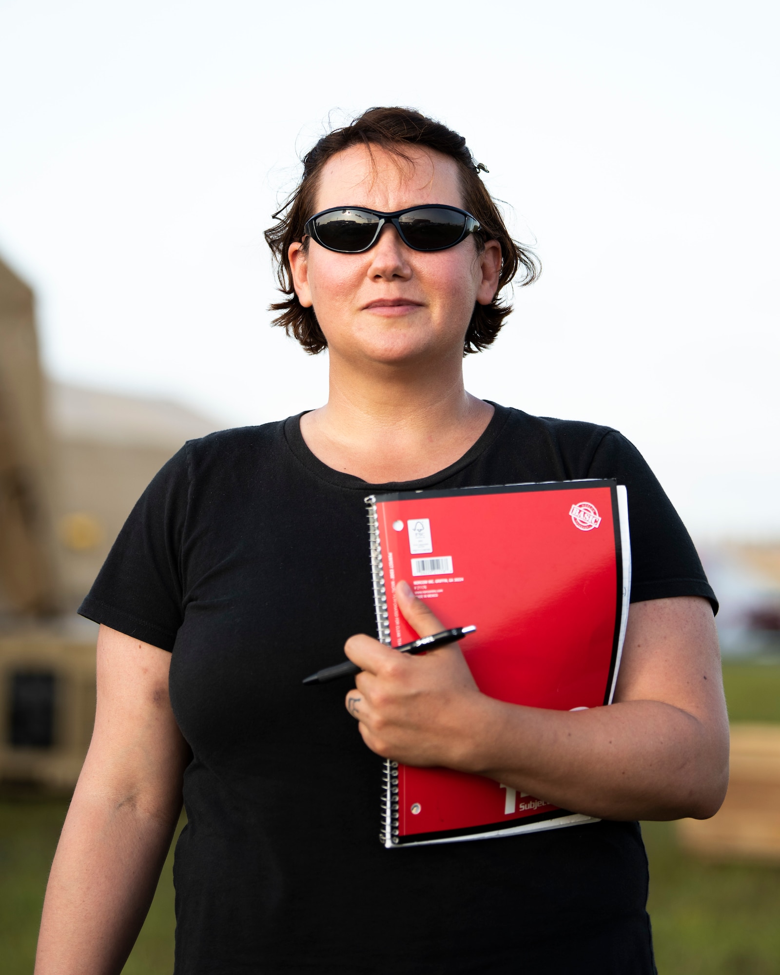 U.S. Air Force Chrissie Reilly, 366th Fighter Wing historian, holds her notebook while standing in the mobile operating base during Agile Flag 21-1 at Tyndall Air Force Base, Florida. Reilly conducts interviews, records observations and collects images that can be used for after-action reports and archived for historical record. (U.S. Air Force photo by Senior Airman Andrew Kobialka)