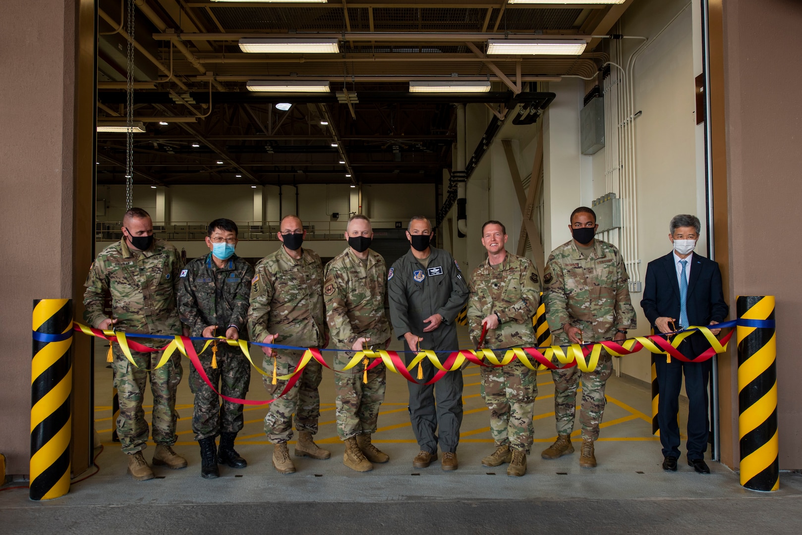 Air Force members prepare to cut a ribbon