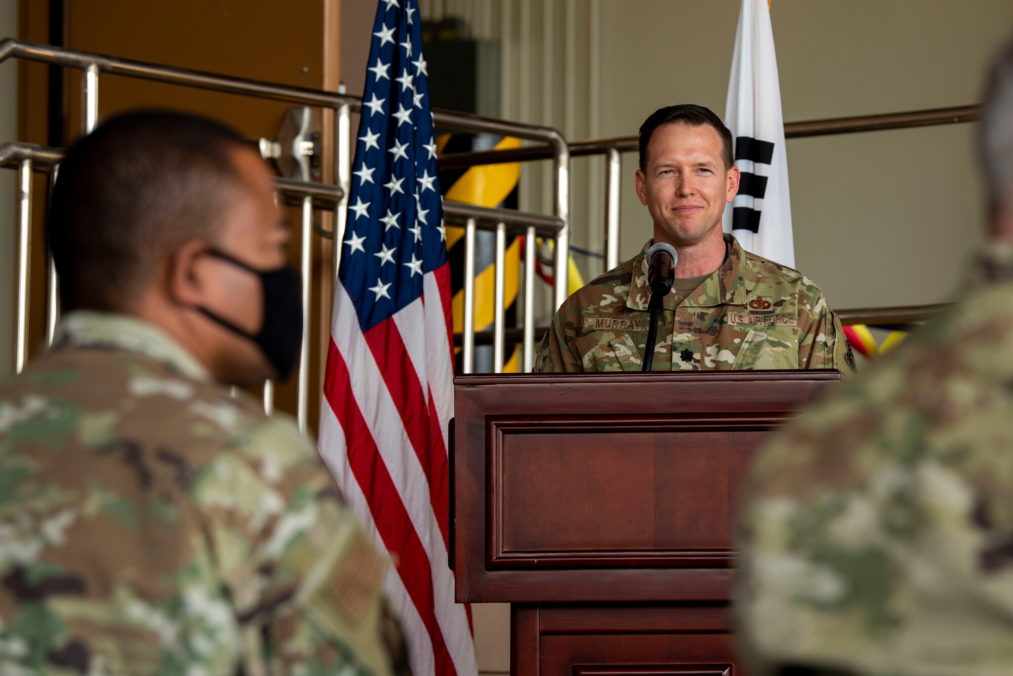 An Airman speaks to a crowd