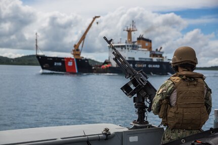 Sailor assigned to Commander, Task Force 75 (CTF 75) observes a U.S. Coast Guard ship during a security patrol aboard a Patrol Boat (PB) Mk VI during maritime operations.