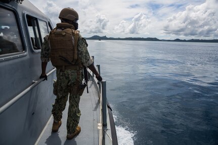 Sailor assigned to Commander, Task Force 75 (CTF 75) surveys environment aboard a Patrol Boat (PB) Mk VI during maritime operations.