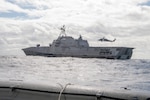 Sailors assigned to the �Wildcards� of Helicopter Combat Squadron (HSC) 23 watch as an MQ-8B Fire Scout takes off aboard the Independence-class littoral combat ship USS Gabrielle Giffords (LCS 10) Oct. 10, 2020.