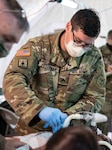 Sgt. Ethan Peterman, a combat medic with the 135th Medical Company, performs a needle decompression procedure on a simulated casualty during the unit's annual training at Fort McCoy, Wis., Aug. 12, 2020. Approximately three-quarters of the 135th Medical Company served on orders for five months, supporting the state's COVID-19 response, before transitioning to annual training.