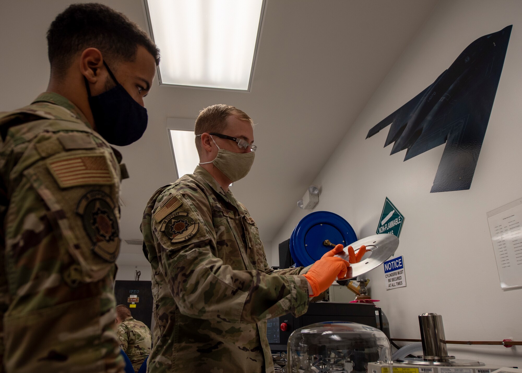 Tech. Sgt. KC Berger, 4th Component Maintenance Squadron physical dimensional element Non-commissioned Officer in Charge (right), trains the use of primary pneumatic pressure standard use to Senior Airman Thiago Santos, 4 CMS electronics technician (left), at Seymour Johnson Air Force Base, North Carolina, Oct. 19, 2020.