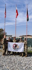 Members of BEST A24 pose with the state of Illinois flag, which was flown during their deployment in Afghanistan.