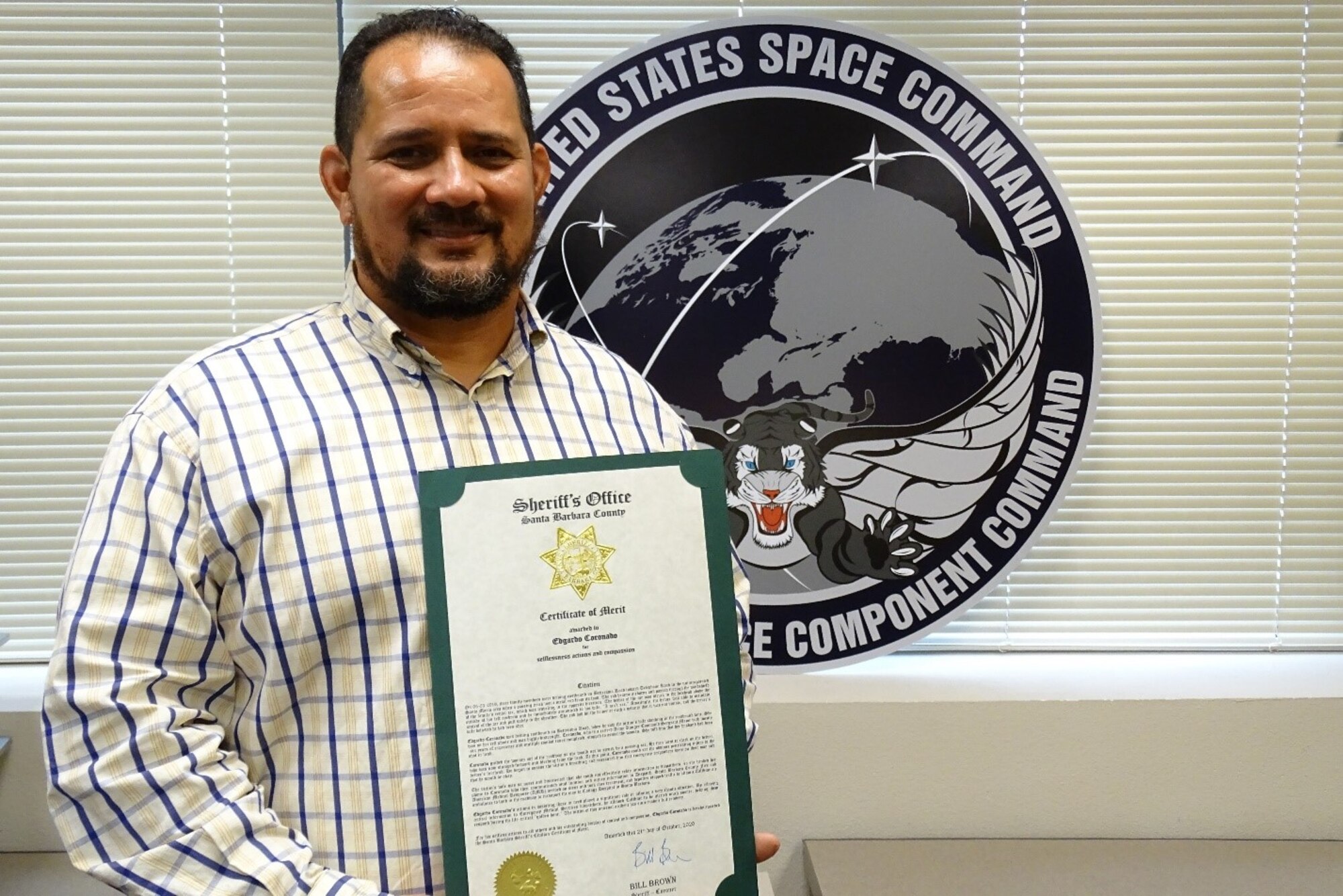 Photo of Mr Edgardo Coronado holding certificate