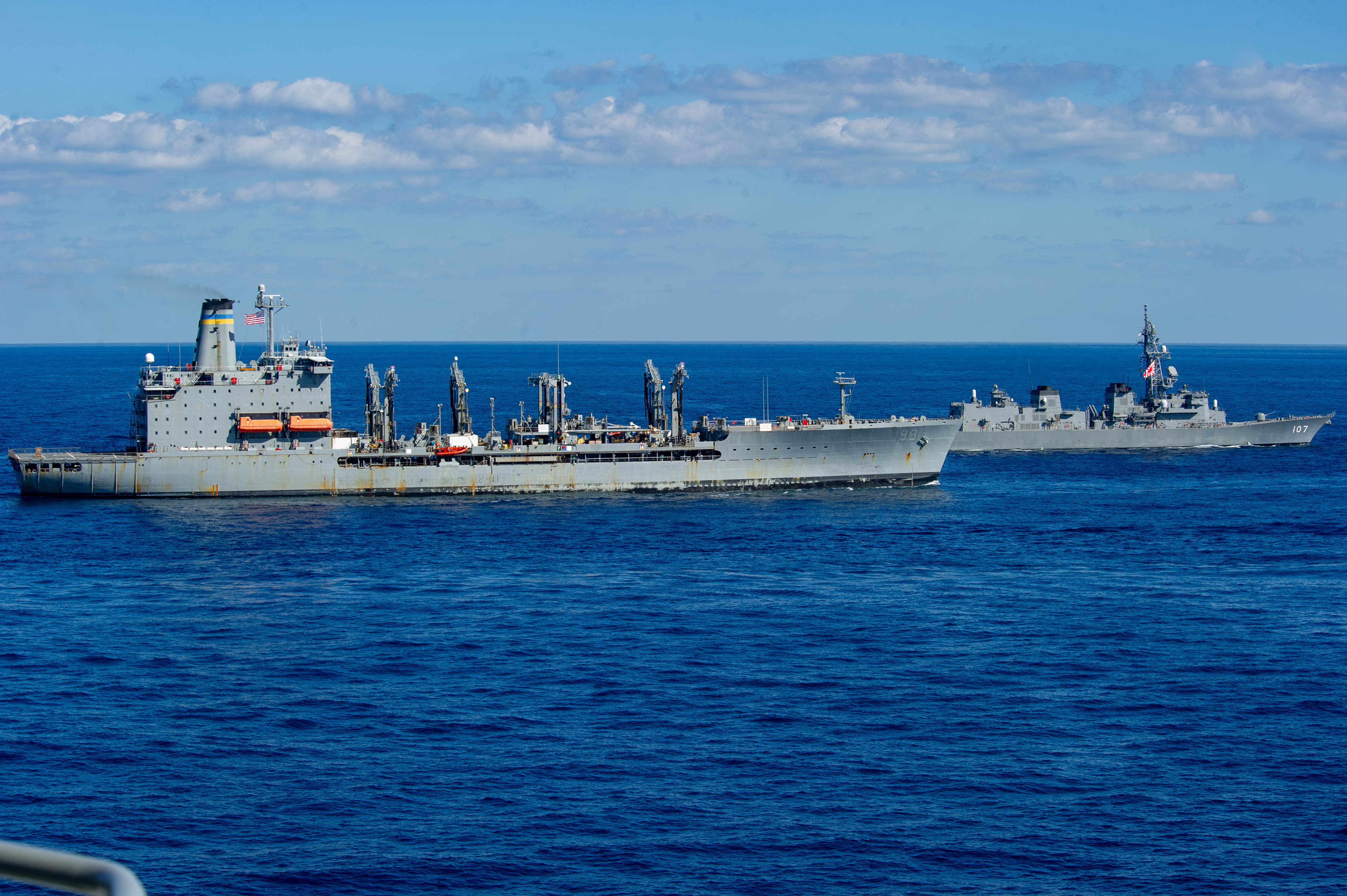 USNS Tippecanoe (T-AO 199), left, and the Japan Maritime Self-Defense Force (JMSDF) destroyer JS Ikazuchi (DD-107) are underway with U.S. Navy ships assigned to the Ronald Reagan Carrier Strike Group,