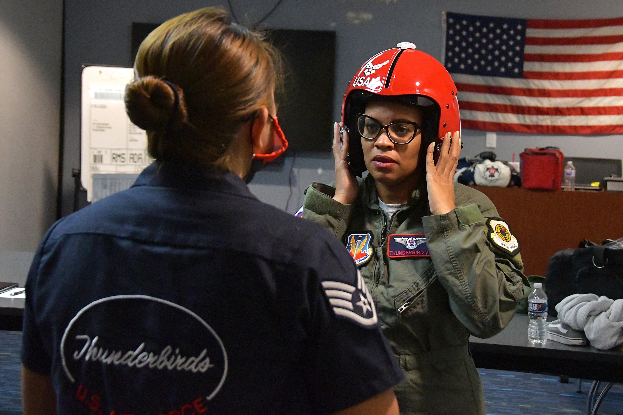 FeFe Handy, founder and president of Page Turners Make Great Learners, tries on a helmet during a fitting at Dobbins Air Reserve Base, Ga., Oct. 23, 2020. Handy flew with the Thunderbirds as a Hometown Hero, a program where exceptional community members are recognized and given the opportunity to fly with the Thunderbirds. (U.S. Air Force photo/Airman 1st Class Kendra Ransum)